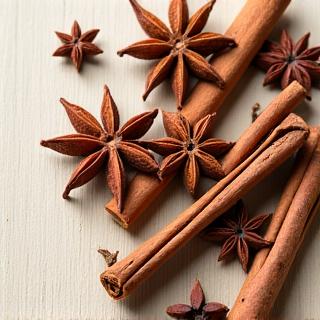 A close-up of a star anise and cinnamon sticks artistically arranged.